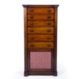 An early Victorian mahogany Wellington chest with six drawers above a brass mesh door and a plinth