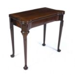 A George III mahogany fold over card table with a green baize top, a single frieze drawer, turned