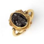 A Sasanian style intaglio carved with an animal and mounted in a yellow metal ring, the stone 1.