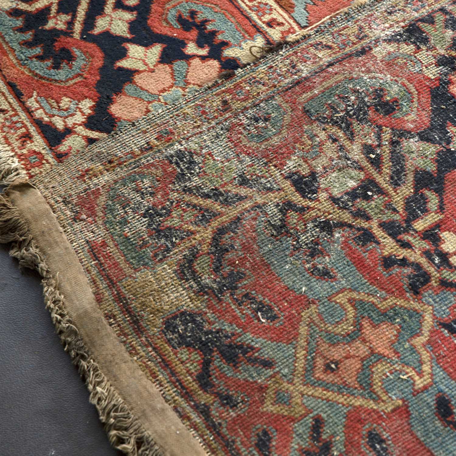 An antique Heriz red ground carpet with geometric decoration 312cm x 412cm old moth damage, - Image 6 of 6