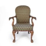 A 20th century Georgain style open armchair with silk upholstery, eagle's head arms, cabriole legs