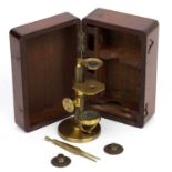 A 19th century French lacquered brass simple microscope with three lenses, 10.5cm in height, in a