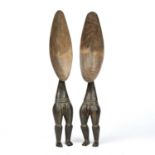 A pair of African Dan ceremonial ladles carved in figural form each 47cm in length.