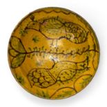 A 19th century north African slipware bowl decorated with exotic birds, 30cm diameter x 9cm highAt