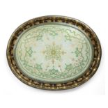 A 19th century gilded papier mache oval tray with a central glass panel having reverse painted