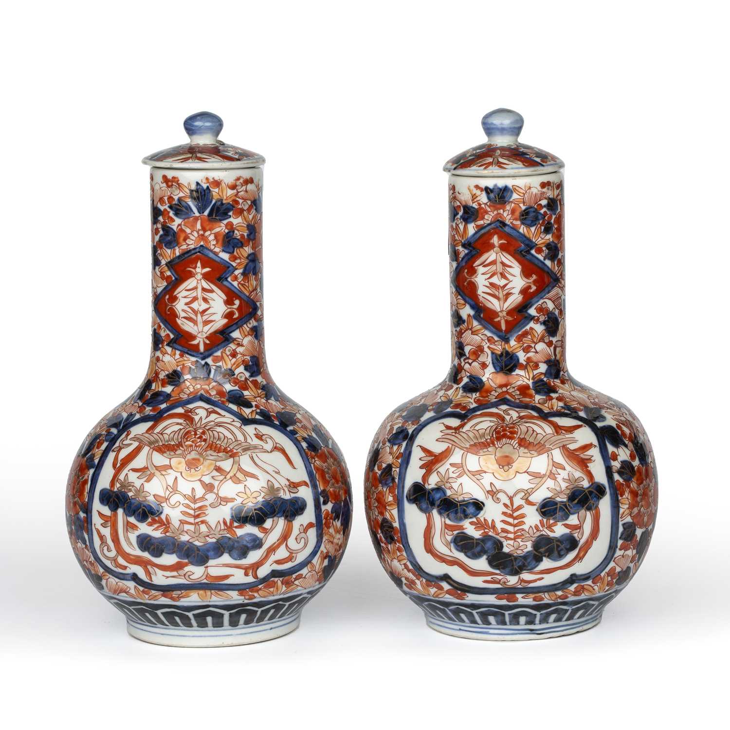 A pair of late 19th century Japanese Imari bottle vases with covers, 15cm wide 27cm high.Good, minor