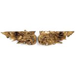 A near pair late 19th/ early 20th century Chinese gilded hardwood wall brackets of dragon form