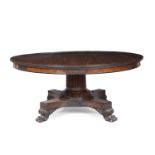 A William IV circular mahogany table with a heavy reeded column stem, platform base with four lion's