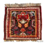 An antique Kurdish Bagface with an orange and brown ground and a flame design, 43cm x 40cmRepair