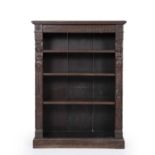 A 19th century English oak open front bookcase with carved terms, adjustable shelves and a plinth
