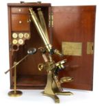A Victorian lacquered brass binocular compound microscope with four objectives and a fitted mahogany