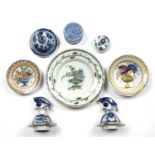 Three Dutch Delft plates, an 18th century pounce pot, 7.5cm diameter and four tin glazed lids (8)