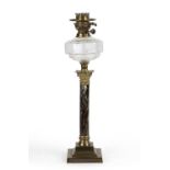 A late 19th / early 20th century German oil lamp with a cut glass well, a marble enamelled
