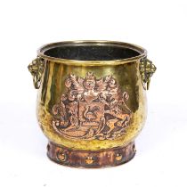 An early Victorian brass and copper log bin with lion's mask ring handles and embossed copper coat