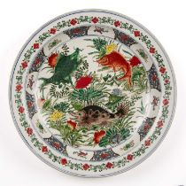 A Chinese porcelain famille verte charger decorated with fish and having a kangxi mark to the