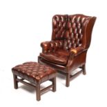 A Georgian style wing back armchair with brown button upholstery and square legs, 85cm wide 68cm