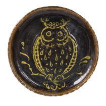 An antique slipware pottery dish decorated with an owl. 34.5cm diameter.