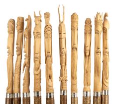 A set of ten birch wood staffs, each carved with medieval characters to include King Arthur and