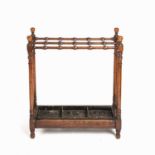 An early 20th century turned oak stick stands with twelve compartments 61cm wide 23cm deep 71cm