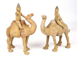 A pair of Chinese Tang style camels with riders each 17cm high 24cm high. Untested From a private