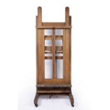 A large early 20th century studio artists easel with adjustable height with four large wooden