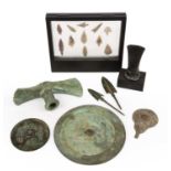 A group of objects to include two bronze axe heads two arrow heads, flint arrow heads and two