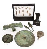 A group of objects to include two bronze axe heads two arrow heads, flint arrow heads and two