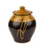 Clive Bowen (1943) a slip ware storage jar and cover 26cm wide 32cm high gluded break to cover.
