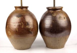 Two early 18th century John Dwight salt glazed stoneware Jars each 34cm high. Both with drill