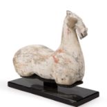 A Chinese Han dynasty (206 BC - 220 AD) painted pottery legless horse 29cm wide 24cm high. Sold with