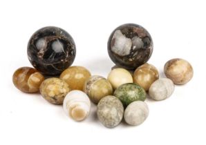 Two polished hard stone spheres 9cm and 8cm together with twelve hardstone eggs. (14)