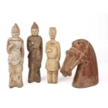 Three Chinese Tang style figures 22cm high and a Tang horse head 17cm wide 17cm high (4)