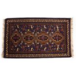A blue and brown ground Afghan rug decorated helicopter designs 117cm x 200cm Good, minor wear.