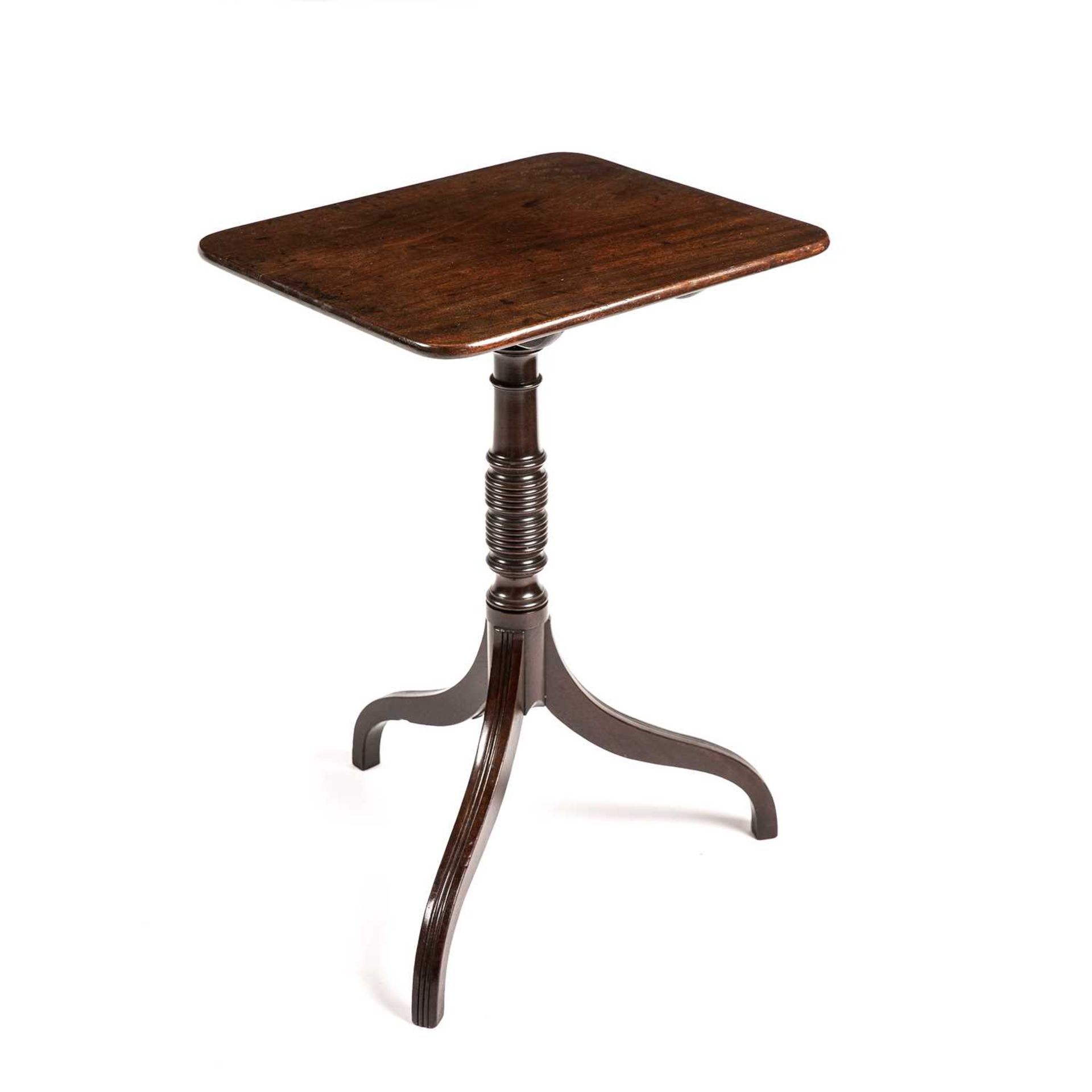 A Regency mahogany tilt top wine table with a turned stem and tripod base. 49cm wide 44cm deep