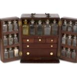 A George III mahogany travelling apothecary cabinet with a brass carrying handle, sliding rear door,