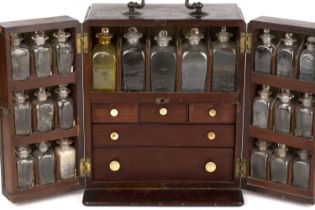 A George III mahogany travelling apothecary cabinet with a brass carrying handle, sliding rear door,