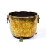 A 19th century brass log bin with lion's mask ring handles and three paw feet 49cm diameter x 37cm