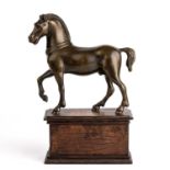 An early 19th century Italian horse, bronze mounted on an oak plinth 20cm wide 28cm high.