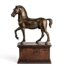 An early 19th century Italian horse, bronze mounted on an oak plinth 20cm wide 28cm high.