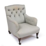 An Edwardian Howard & Sons button upholstered armchair, the back leg stamped 'Howard & Sons Limited,