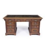 A Victorian oak pedestal desk with a green leather inset top. 154cm wide 75cm deep 74cm high.