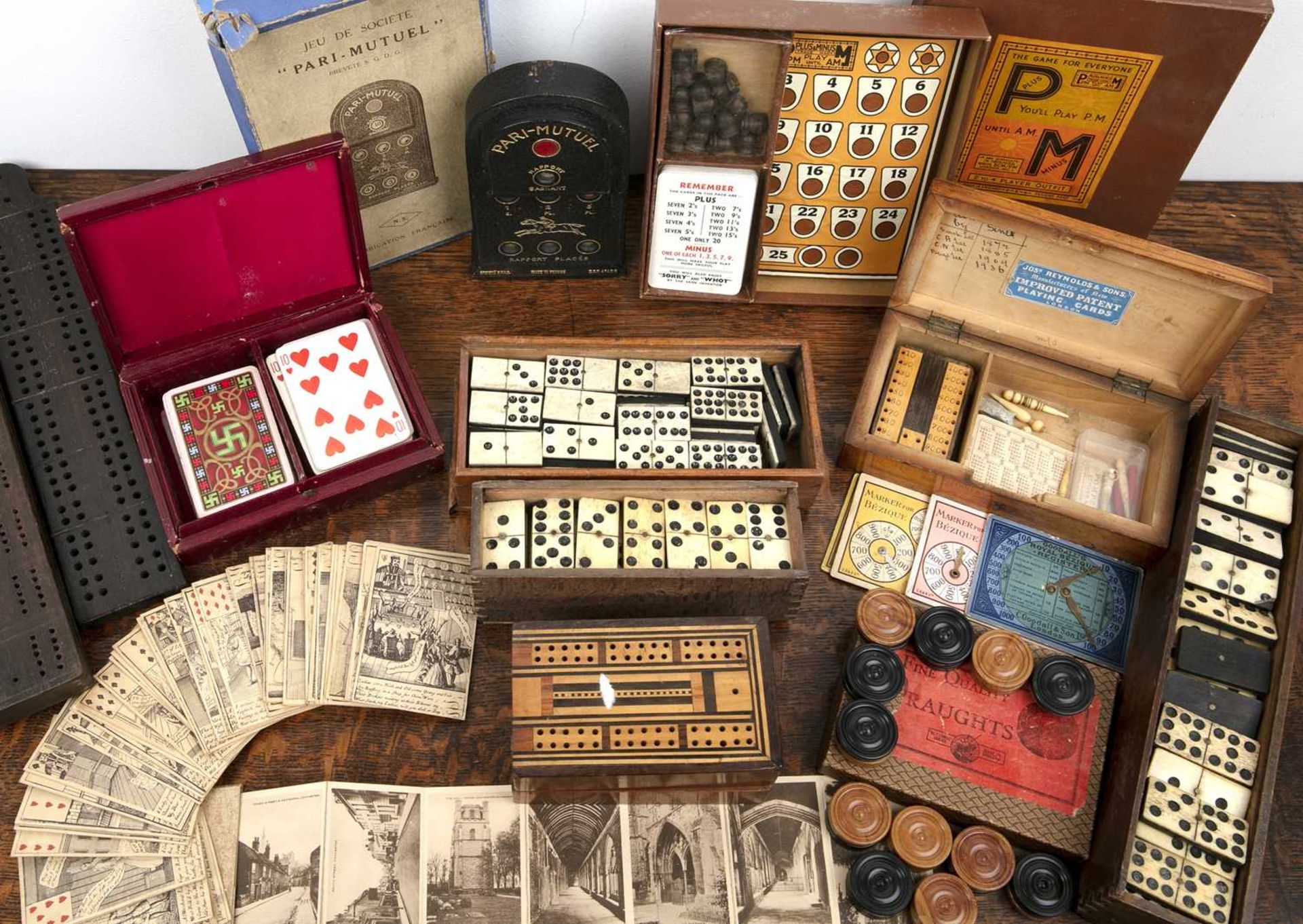 Group of games including a pack of French playing cards, dominoes, crib boards and other pieces
