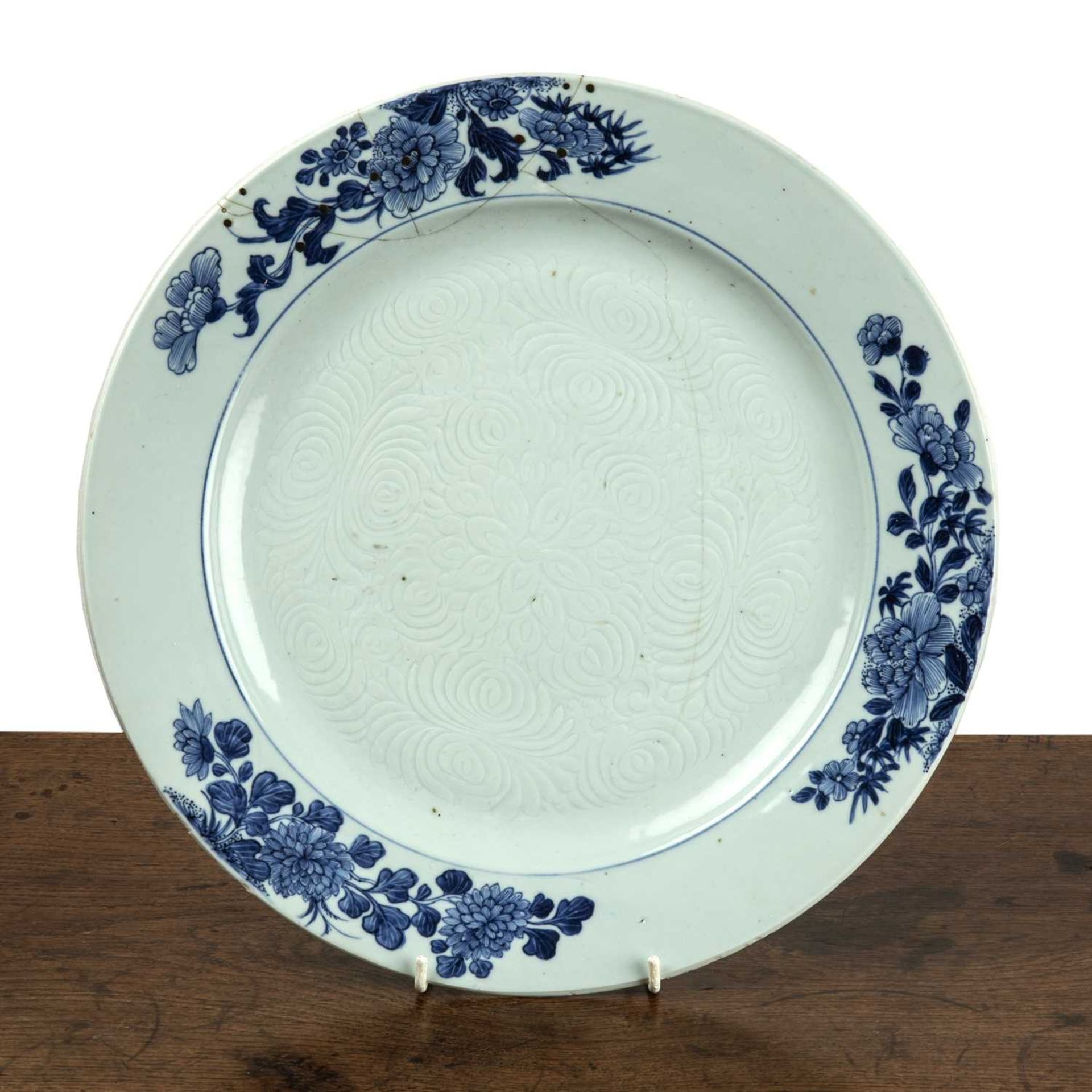 Blue and white porcelain charger Chinese, circa 1800, with a painted border of peonies and