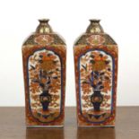 Pair of Arita square bottle vases Japanese, 19th Century, painted with panels of vases of flowers,