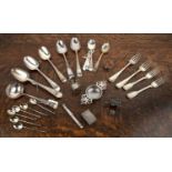 Collection of silver including: large silver serving spoons, forks, teaspoons, tea strainer, sugar