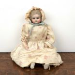 Antique childs doll with unidentified ink markings to the top of the back, painted glass eyes,