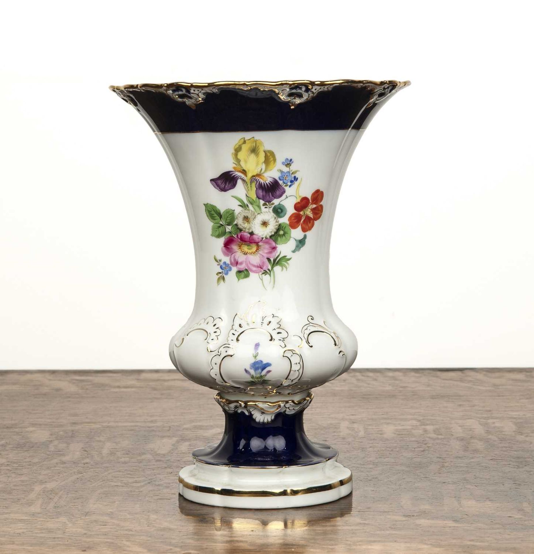 Meissen porcelain urn shaped vase with flaring rim on shaped base, decorated with flowers on a white