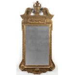 Giltwood wall mirror in the manner of William Kent George II, circa 1740, with a broken scroll