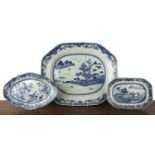 Three blue and white export dishes Chinese, circa 1800, the largest meat plate with tree and