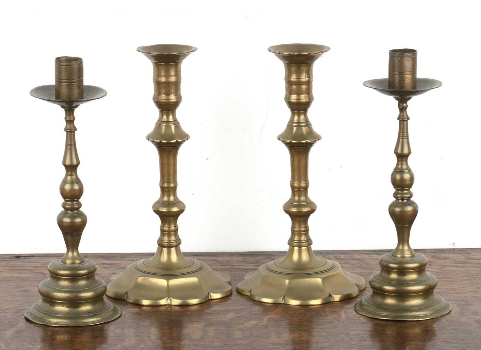 Two pairs of Continental brass candlesticks 18th Century and later, the smaller pair on shaped lotus - Image 2 of 3